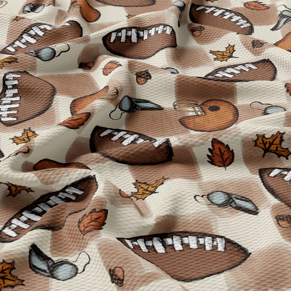 a close up of a fabric with a pattern of footballs and leaves