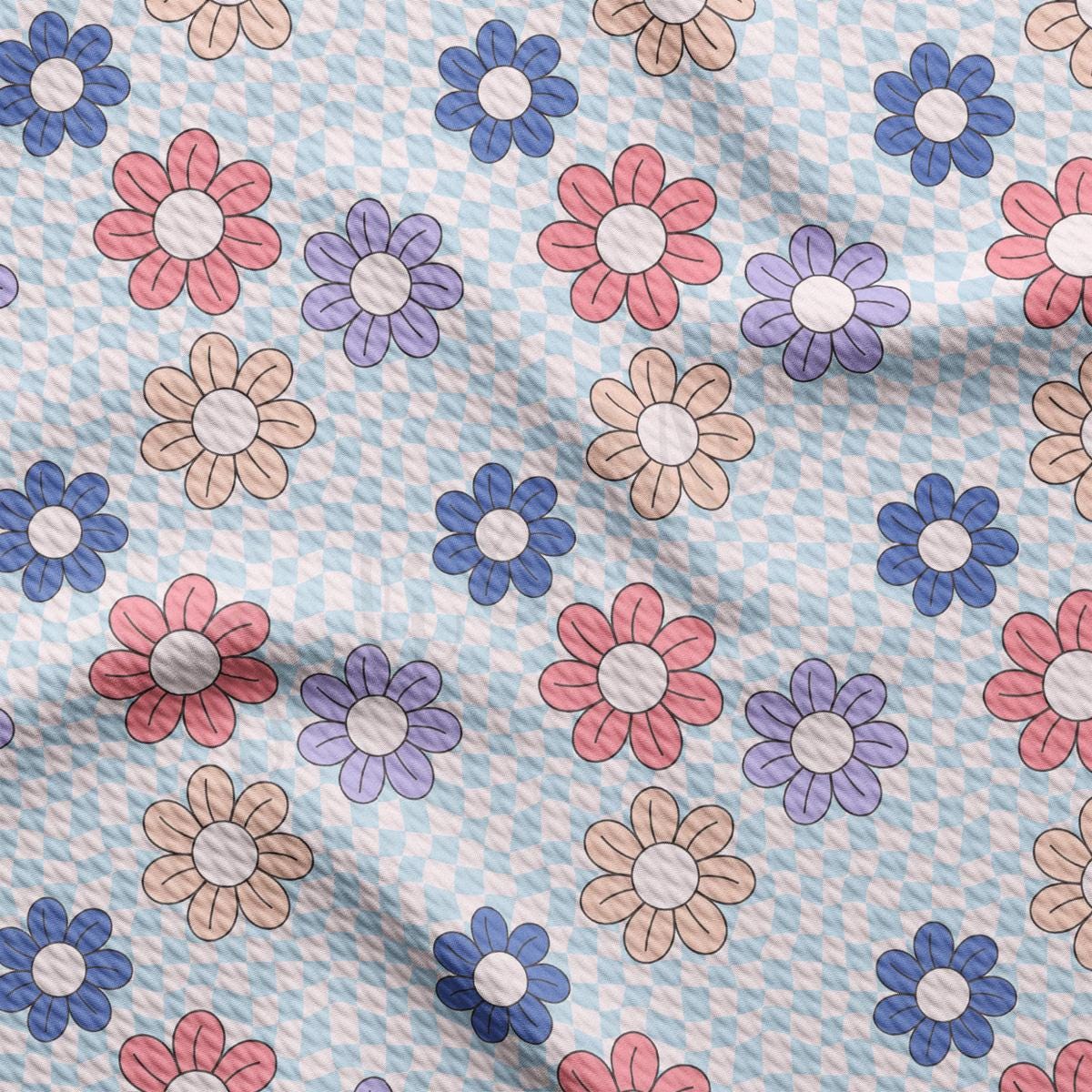 a blue and white checkered fabric with flowers on it