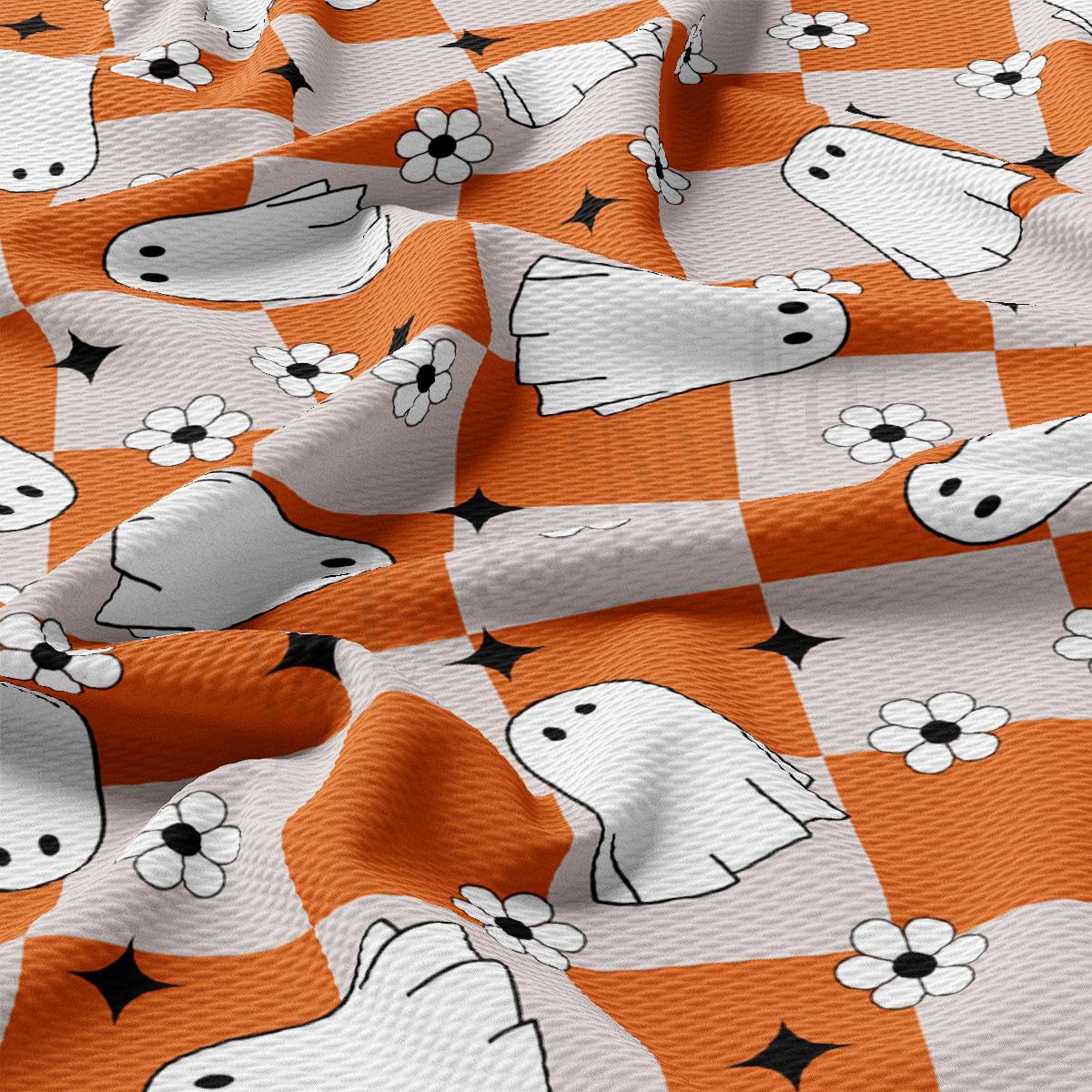 an orange and white checkered fabric with black and white dogs on it