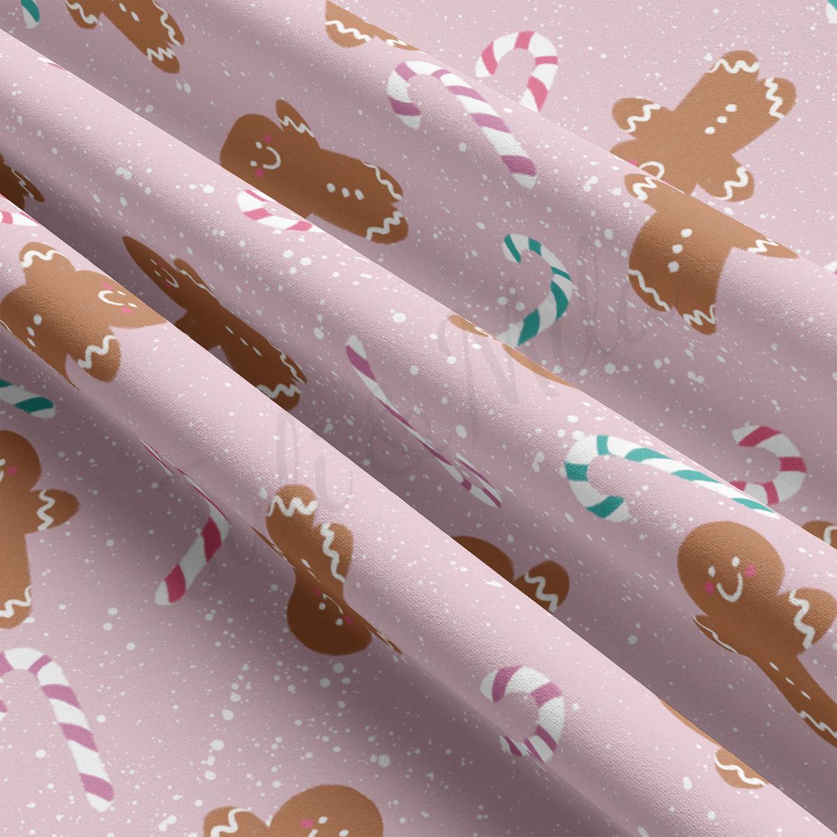 a pink background with gingerbreads and candy canes