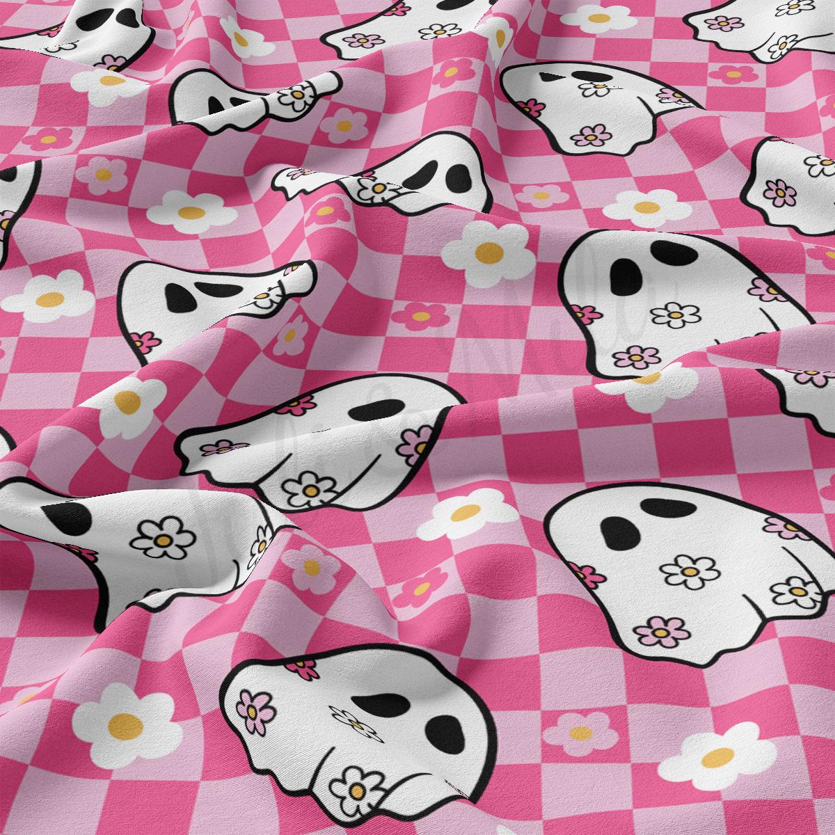 a pink and white checkered fabric with skulls and flowers