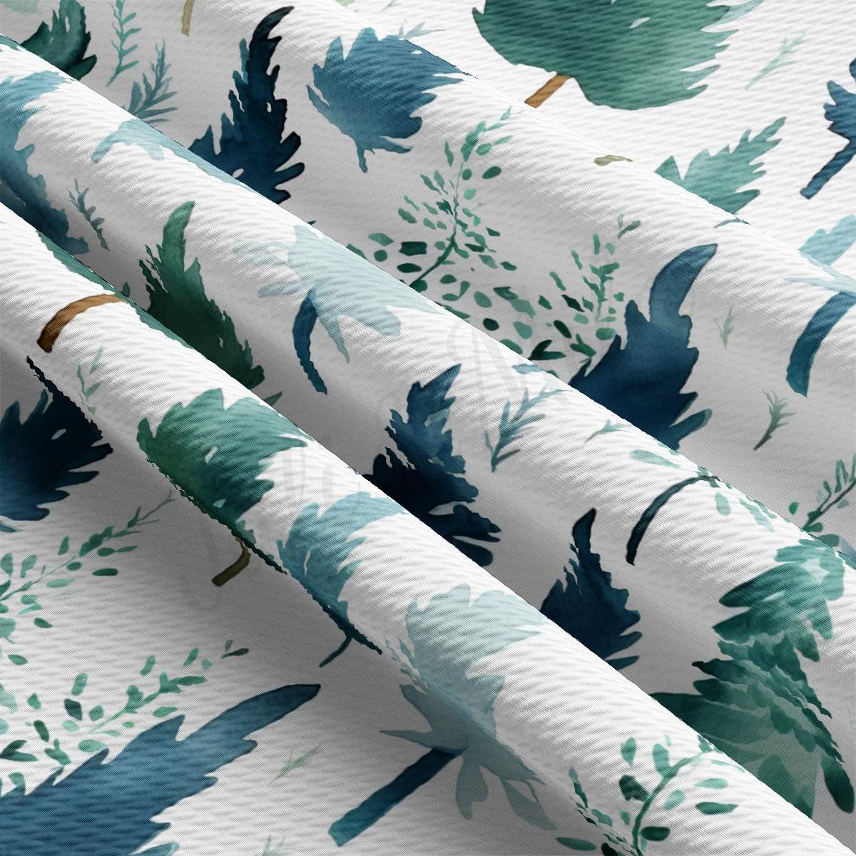 a close up of a white fabric with trees on it
