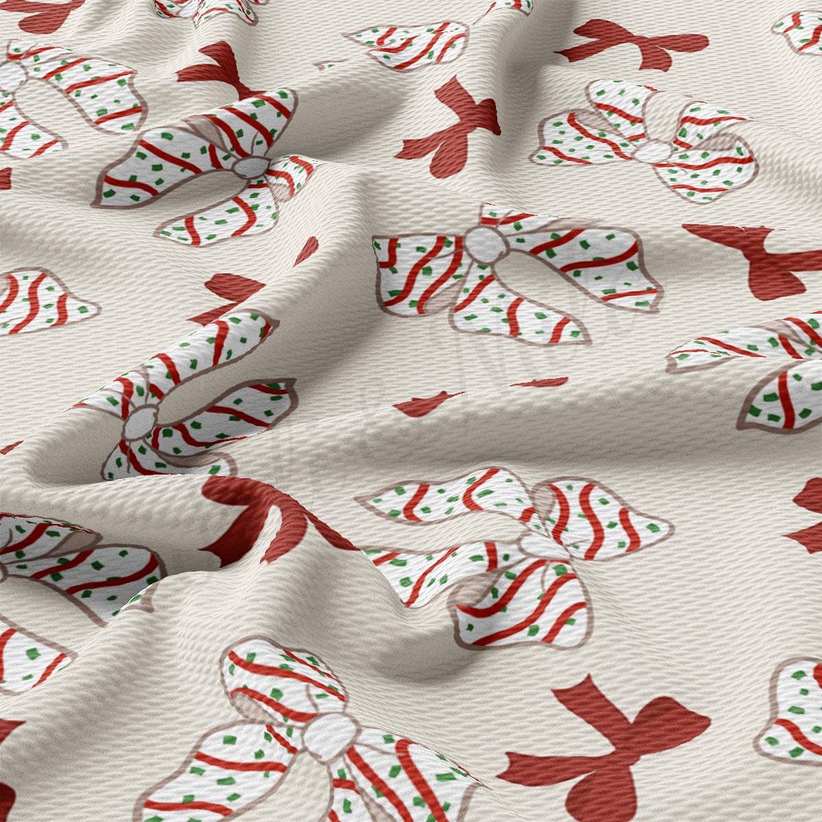 a close up of a white fabric with red and green bows