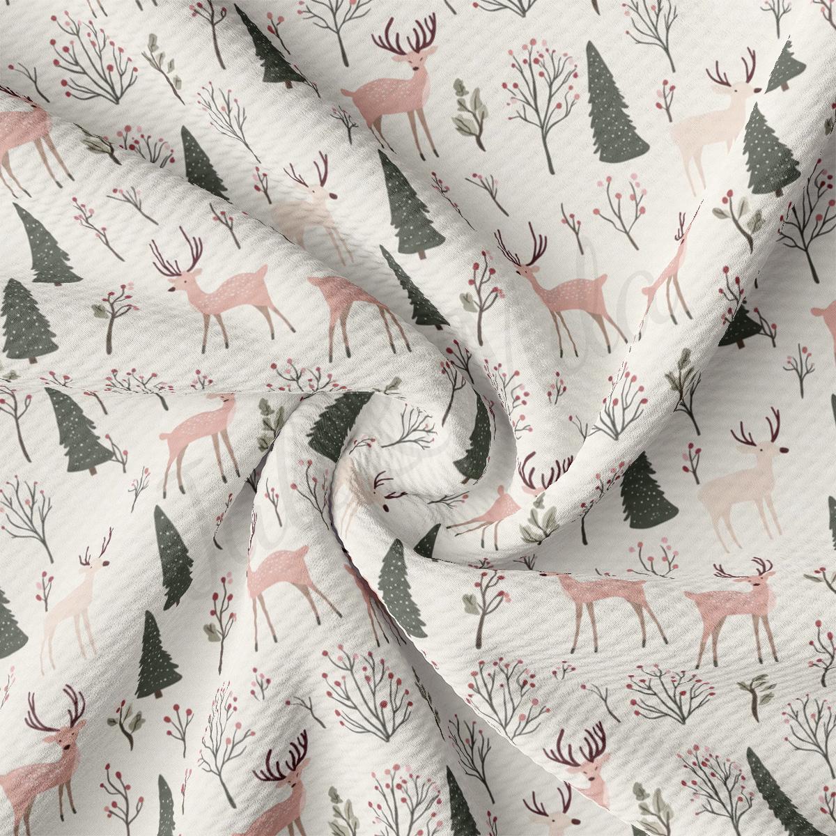 a white fabric with deer and trees on it