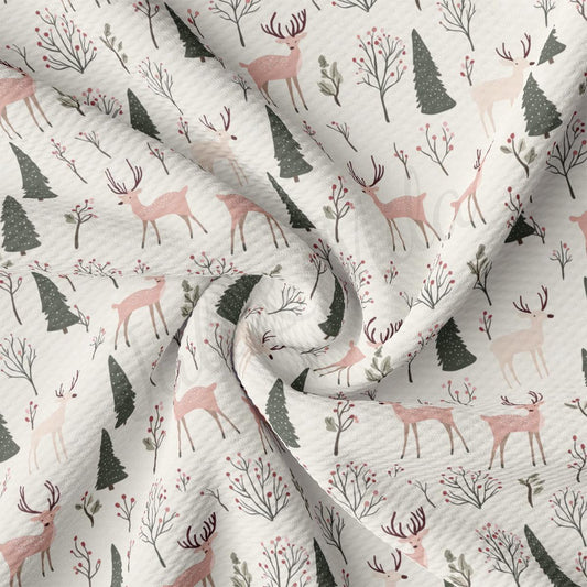 a white fabric with deer and trees on it