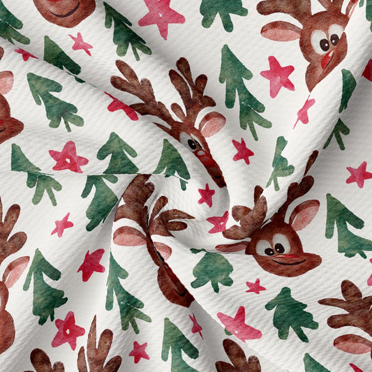 a close up of a white fabric with reindeers on it