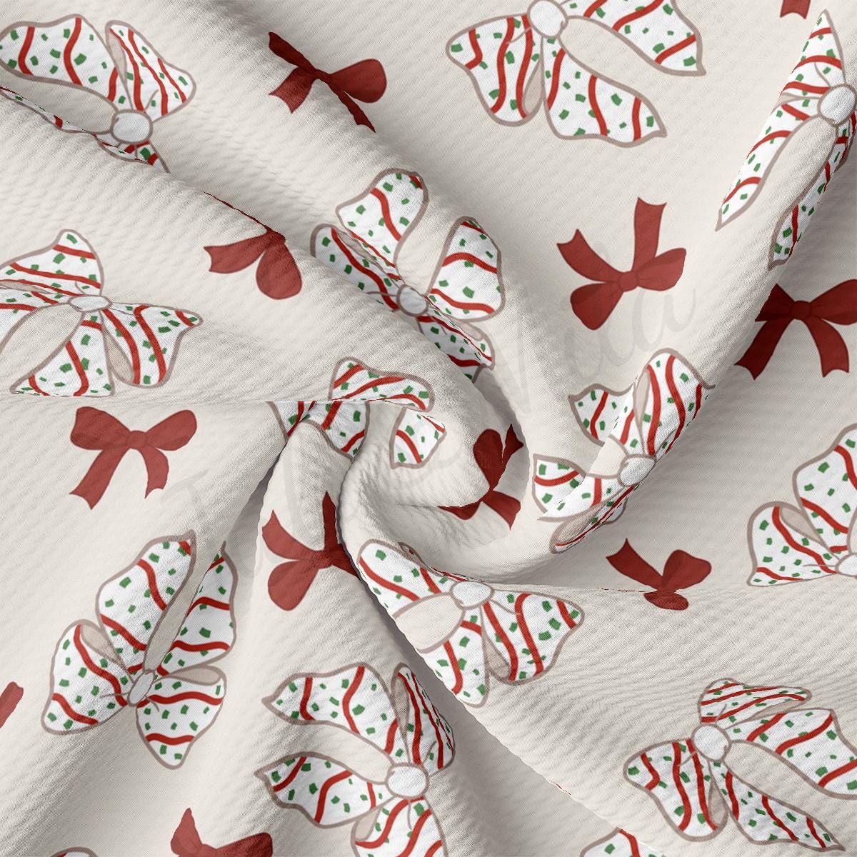 a close up of a white fabric with red and green bows