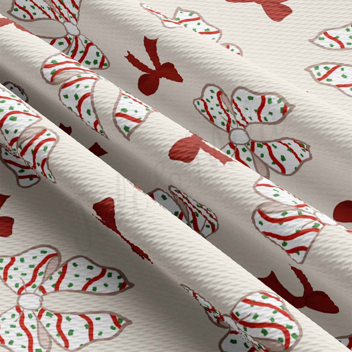 a white wrapping paper with red and green bows on it