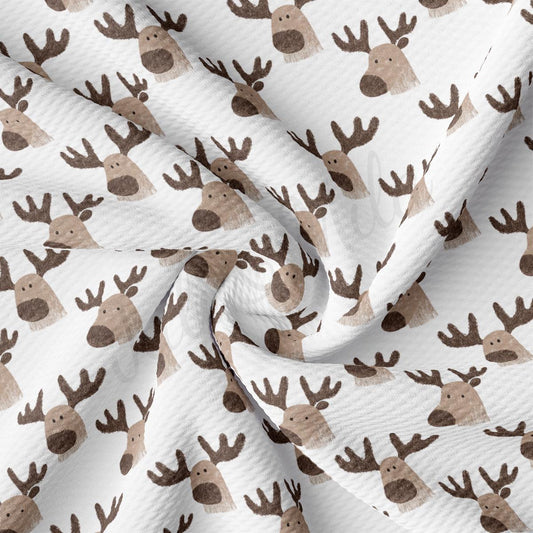 a close up of a white and brown reindeer print fabric