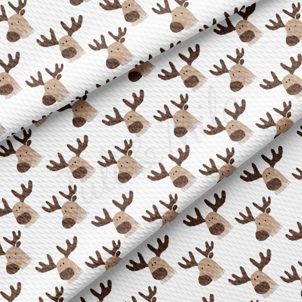 a pattern of brown and white reindeer heads on a white background