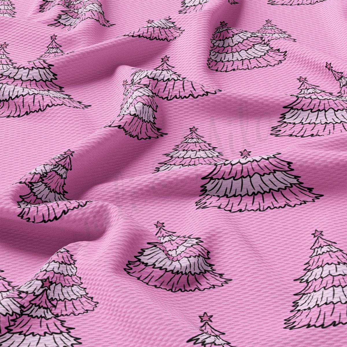 a pink fabric with white and black christmas trees on it