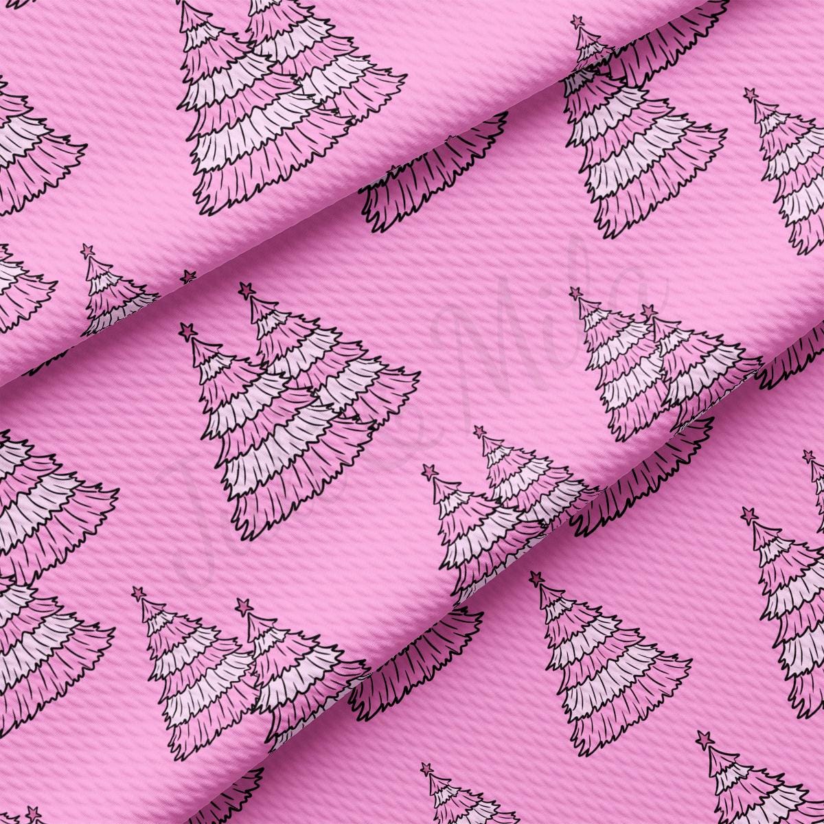 a pink background with white christmas trees on it